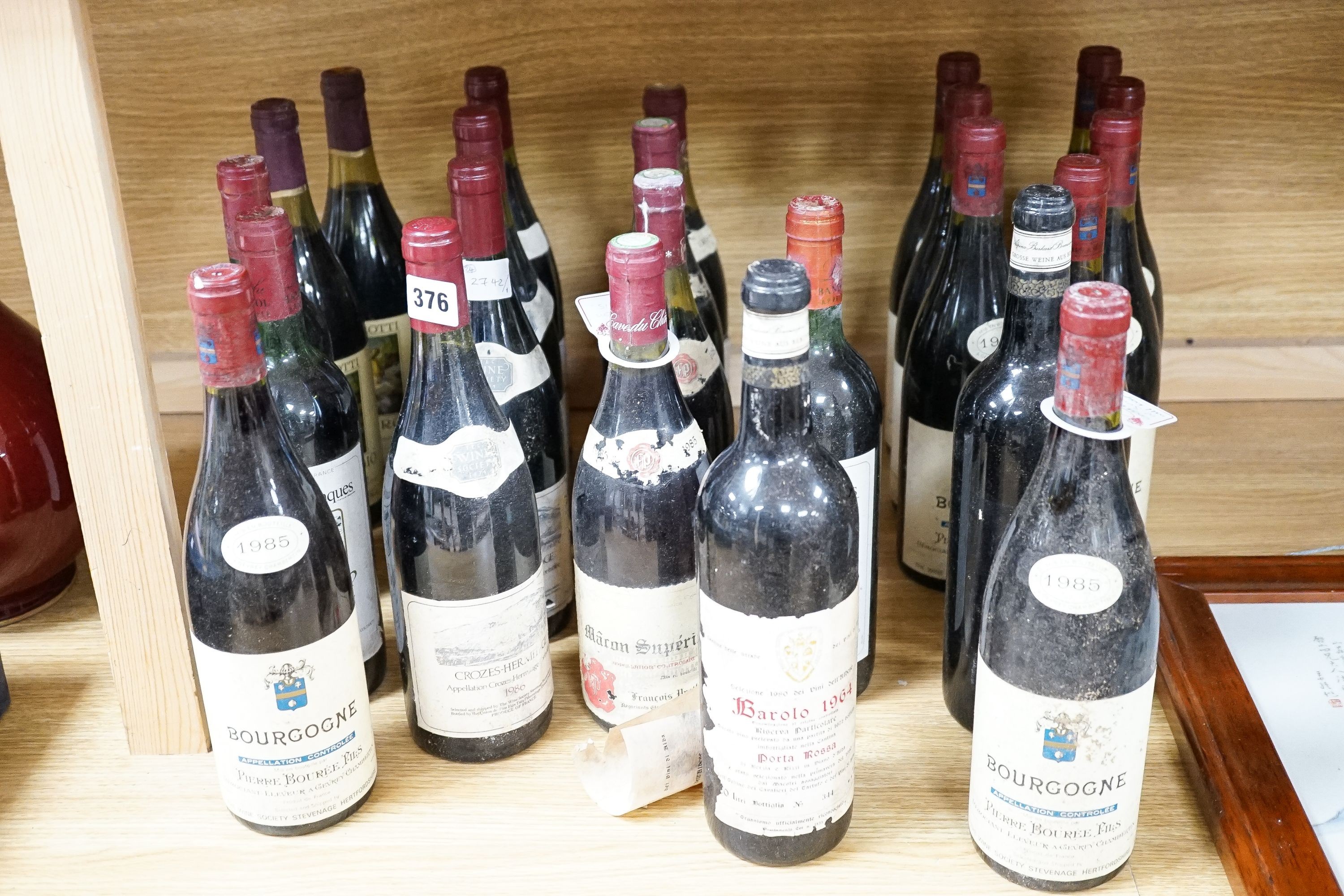 A collection of 24 bottles of red wines including 9 bottles of 1985 Bourgogne, 2 bottles of 1964 Barolo, 4 bottles 1986 Crozes Hermitage